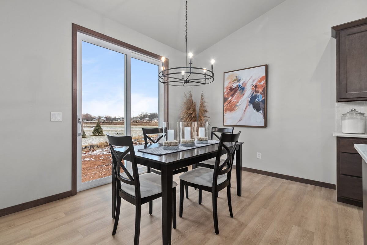 Dining space with modern chandelier in custom home by Midwest Design Homes, Appleton WI