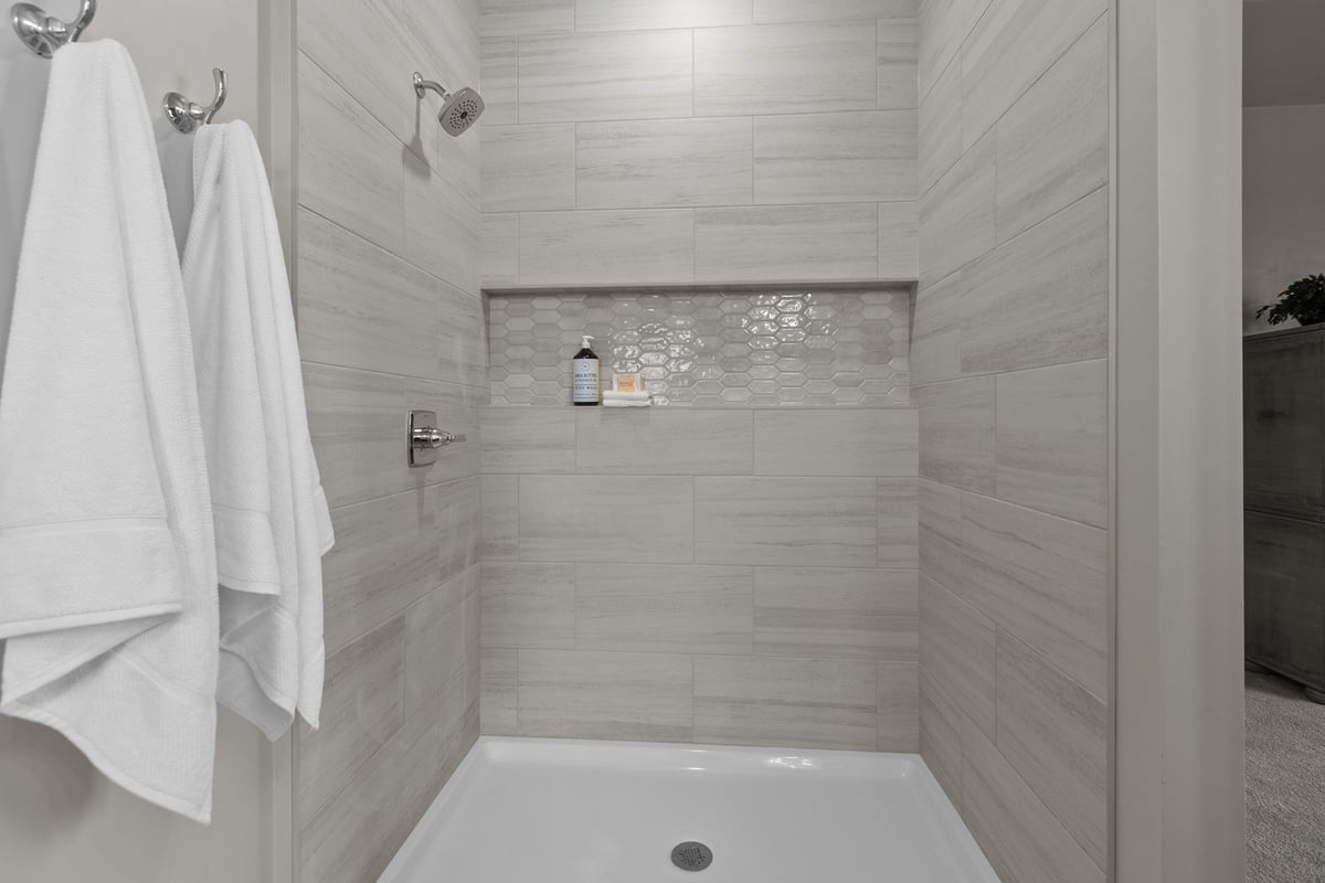 Dual towel hook and tile shower in custom Appleton, WI home by Midwest Design Homes