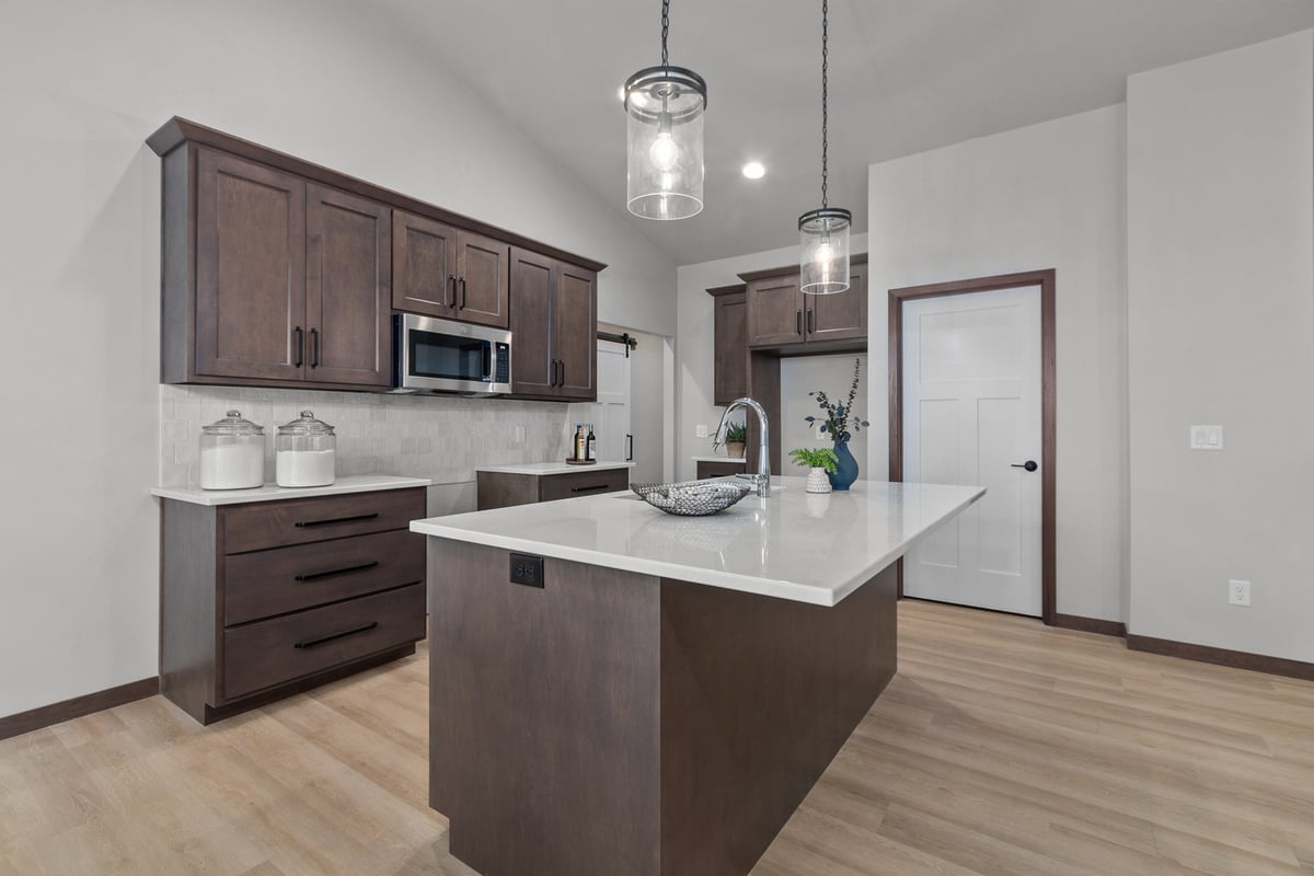 Kitchen island with pendant lights in a custom home by Midwest Design Homes, WI