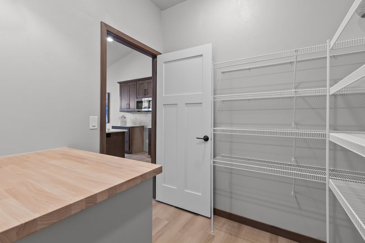 Kitchen pantry with wire shelving in custom home by Midwest Design Homes, Appleton WI