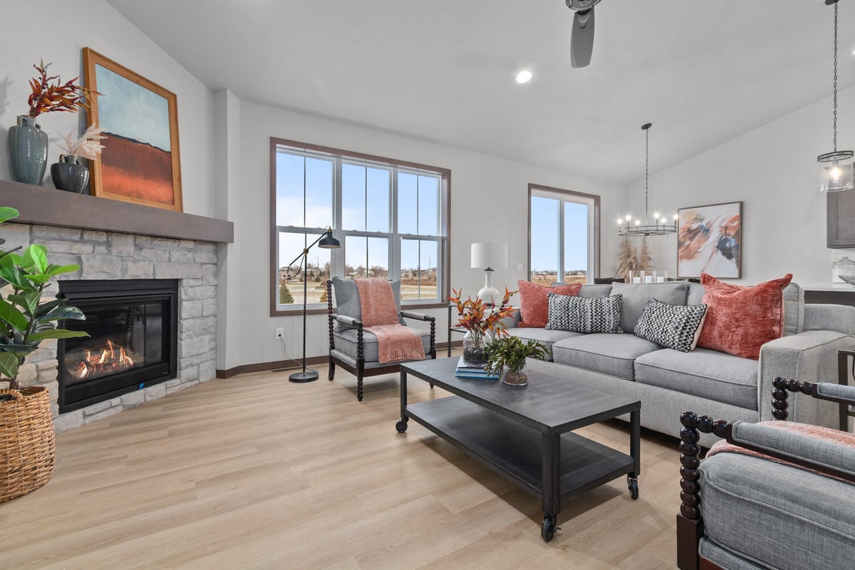 Living room with fireplace and large windows in a custom home by Midwest Design Homes WI