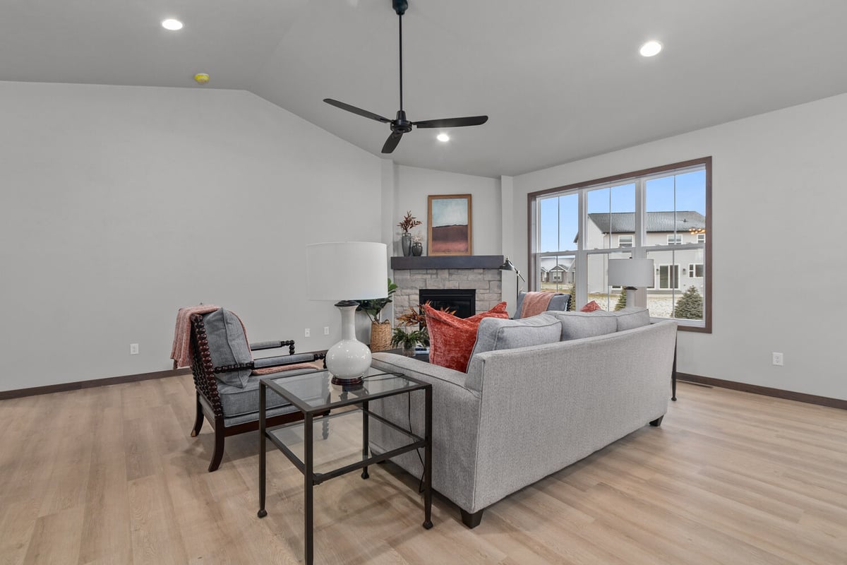Living room with view of backyard and fireplace by Midwest Design Homes in Wisconsin
