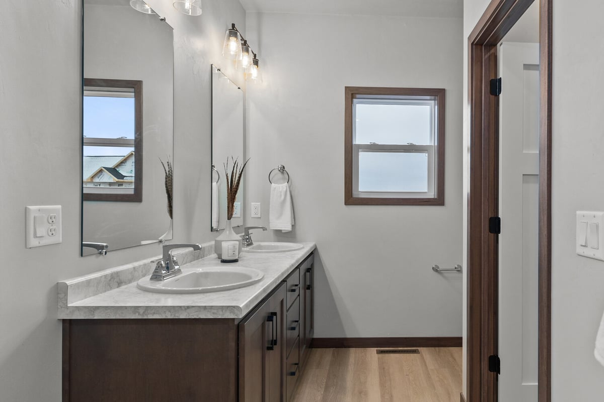 Primary bath vanity with dual sinks by Midwest Design Homes in Fremont, WI