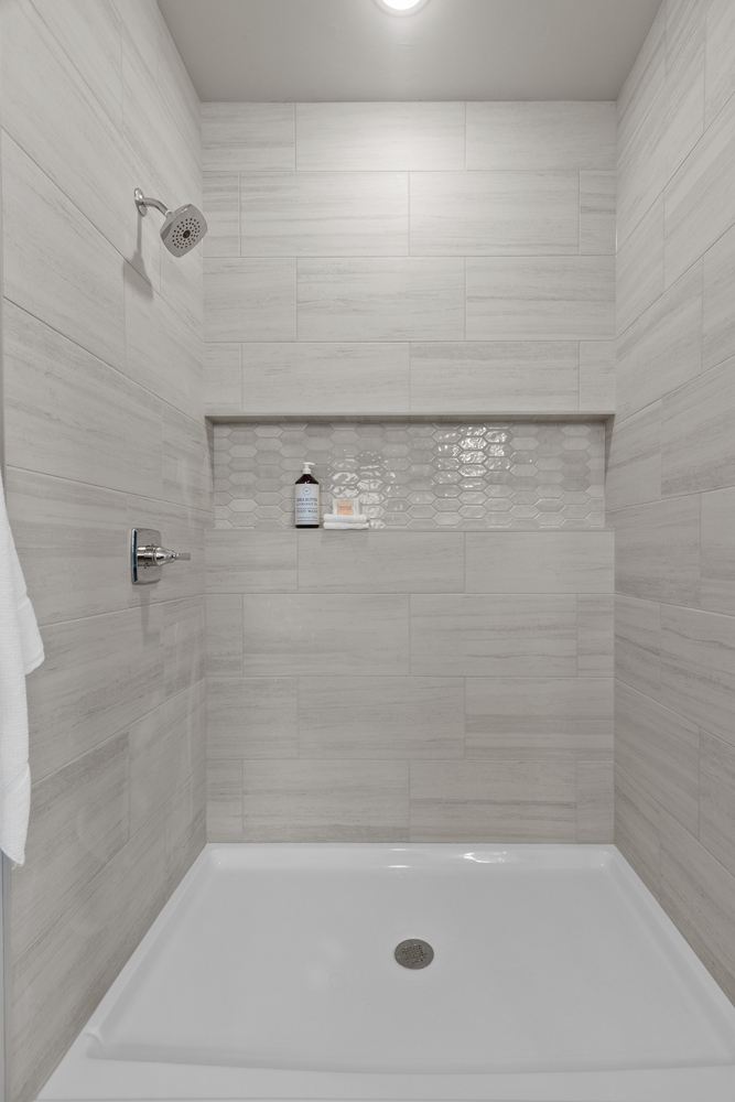 Shower niche and tile design by Midwest Design Homes in Greenville, WI custom home