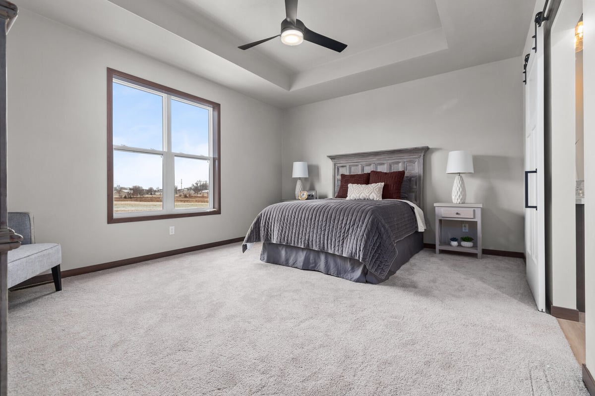 Spacious bedroom with large windows in Lawrence, WI by Midwest Design Homes