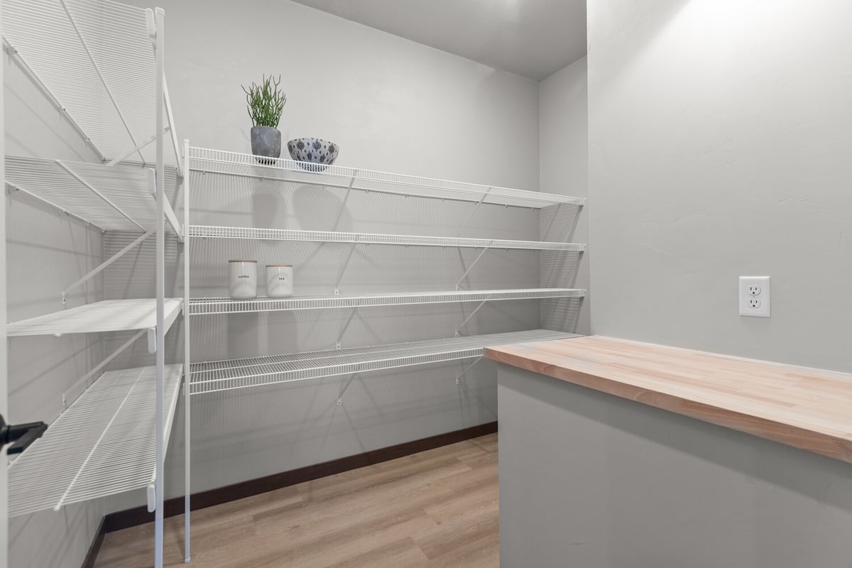 Storage pantry with wire shelves in a Fremont WI custom home by Midwest Design Homes