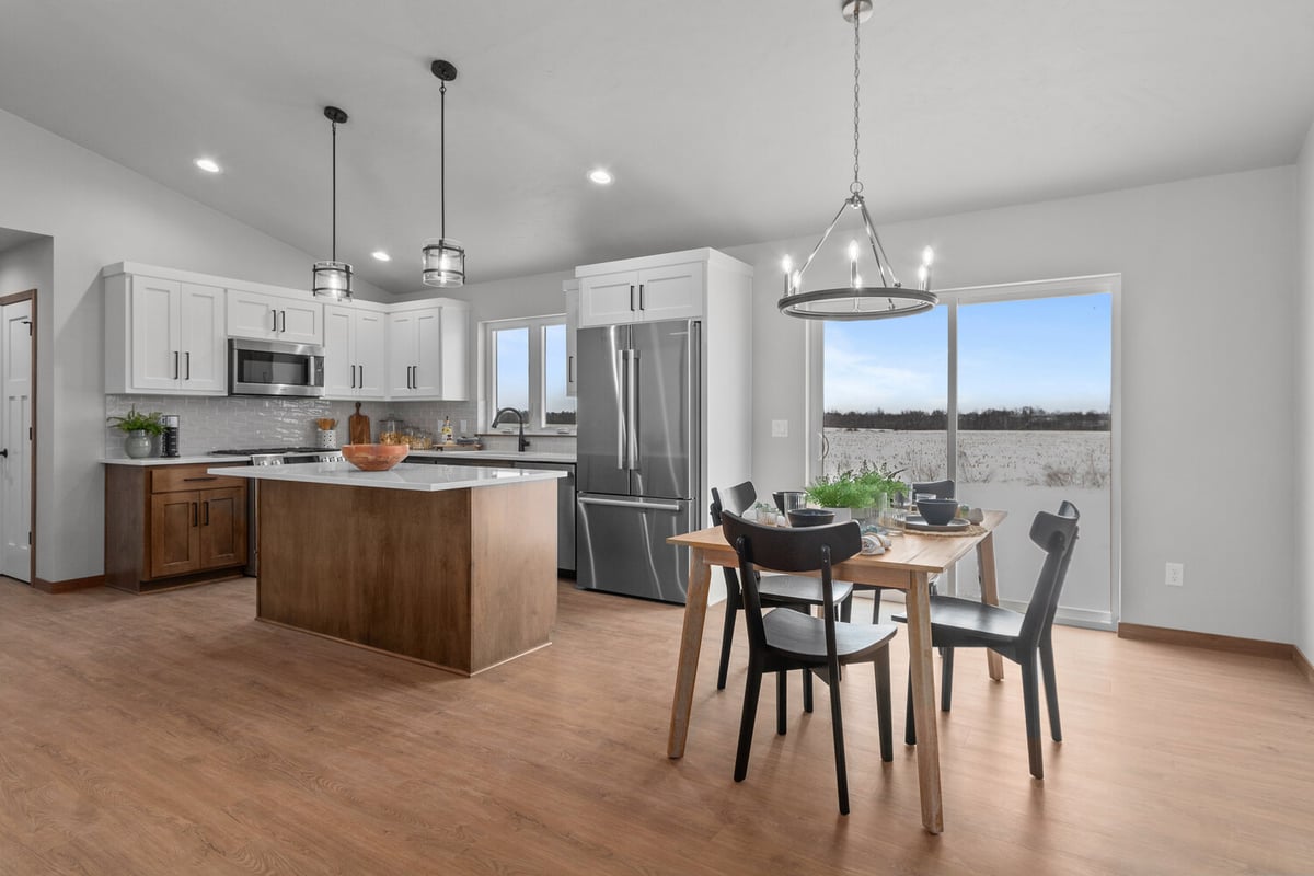Custom kitchen and dining area by Midwest Design Homes in Kaukauna, WI with pendant lighting