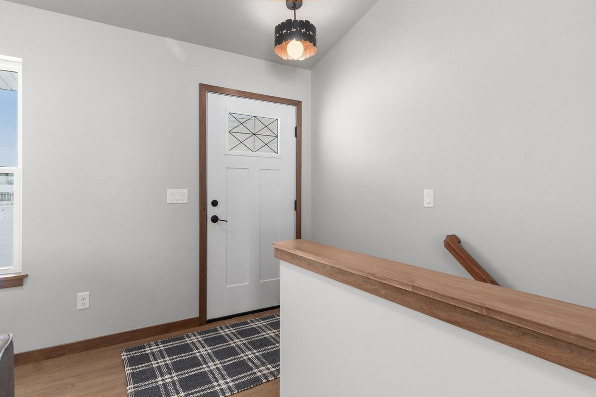 Entryway with white door and warm accents in Midwest Design Homes custom home in Kaukauna, WI