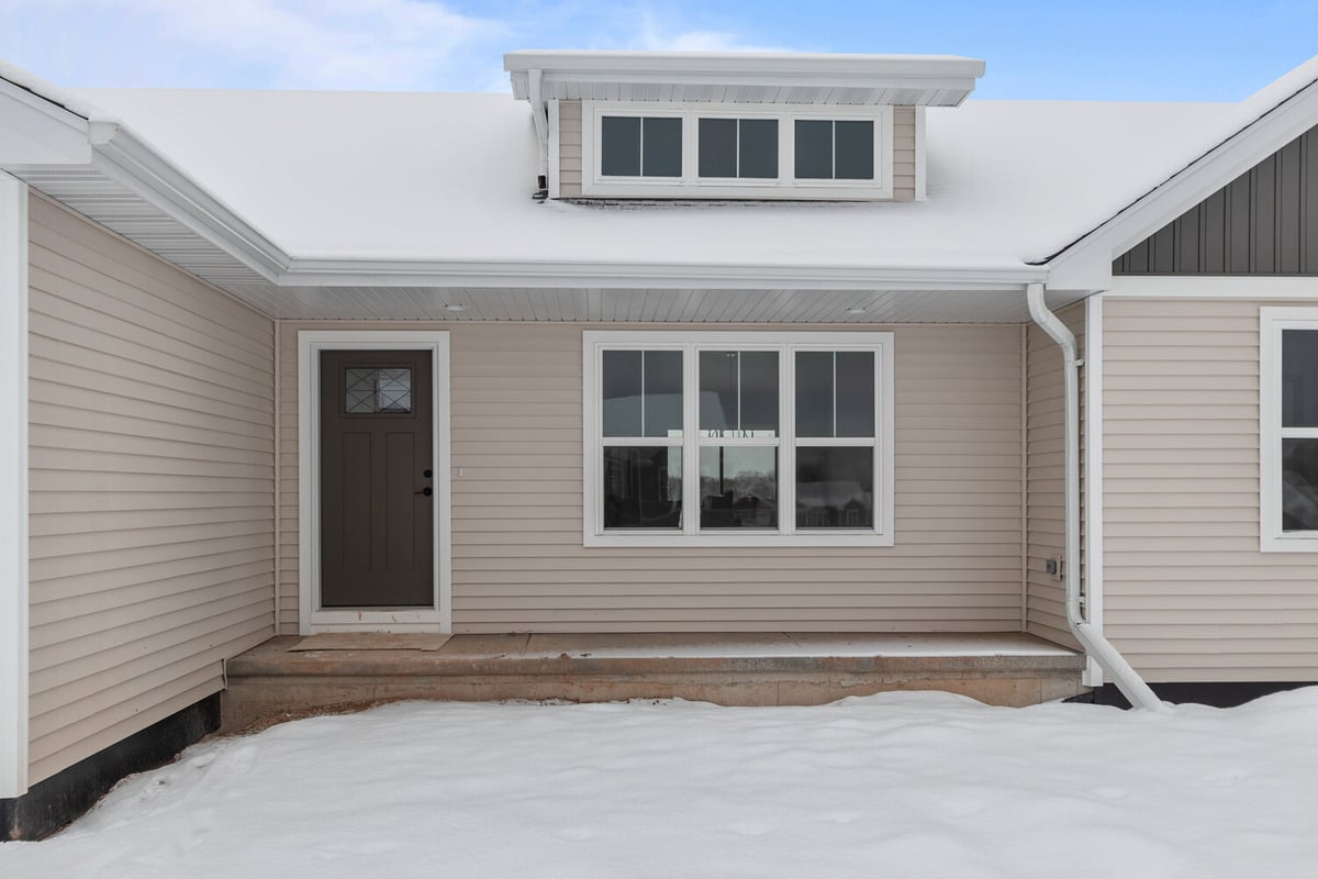 Front porch and windows of custom home by Midwest Design Homes in Kaukauna, WI in winter