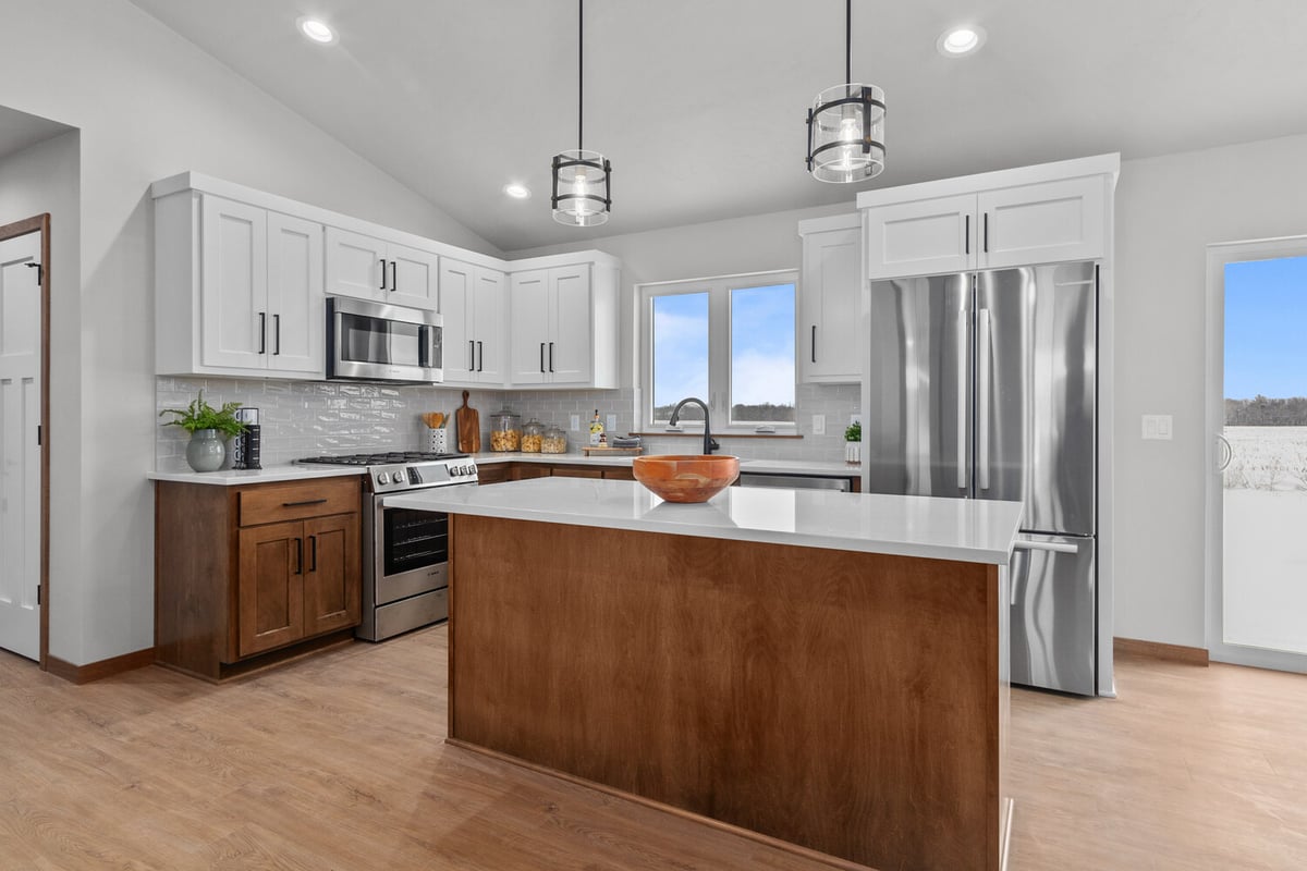 Kitchen with pendant lights and breakfast bar in Midwest Design Homes project in Kaukauna, WI