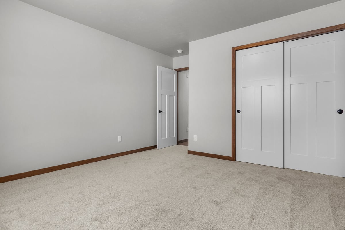 Midwest Design Homes custom-built bedroom with closet doors in Kaukauna, WI area