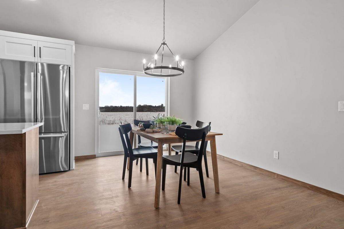 Modern dining area next to sliding glass doors in a Midwest Design Homes custom home in Kaukauna WI