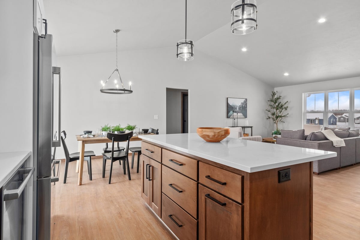Open kitchen and living layout in a custom Kaukauna, WI home by Midwest Design Homes