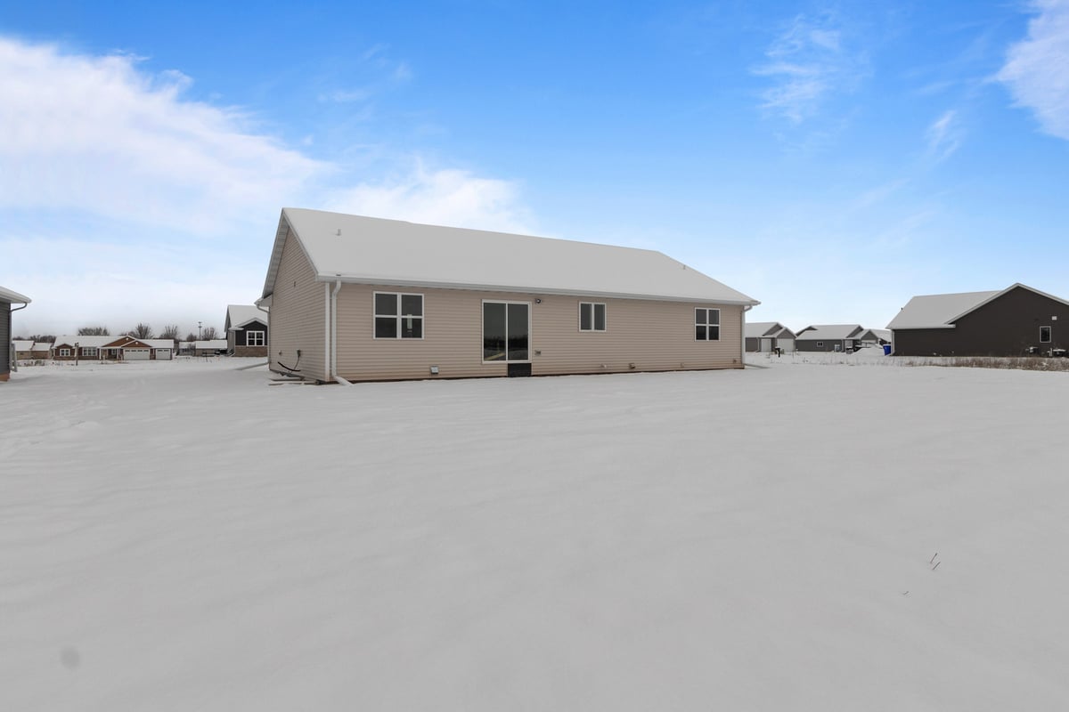 Rear exterior of custom home by Midwest Design Homes in Kaukauna, WI surrounded by snow