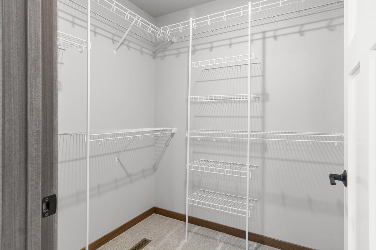 Spacious walk-in closet with wire shelving in custom home by Midwest Design Homes in Kaukauna, WI
