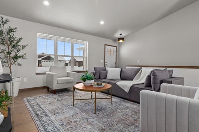 Sunlit living room with front door view in custom Kaukauna, WI home by Midwest Design Homes