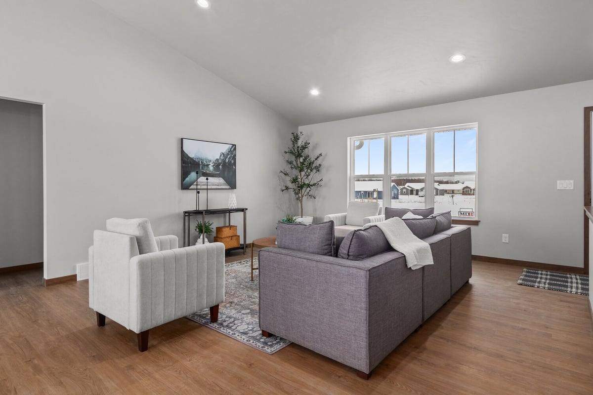 Window-lit family space with area rug in Kaukauna, WI home built by Midwest Design Homes