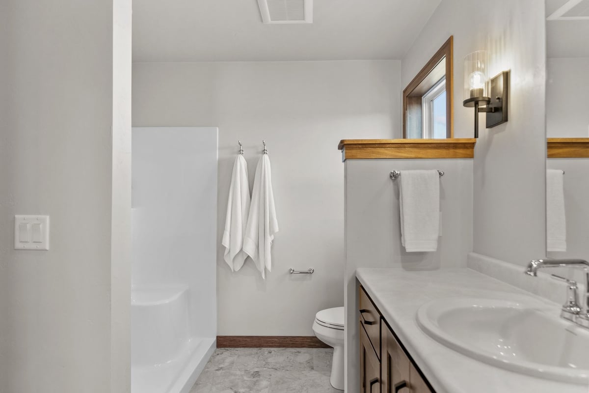 Bathroom with double vanity and shower in custom build by Midwest Design Homes, WI