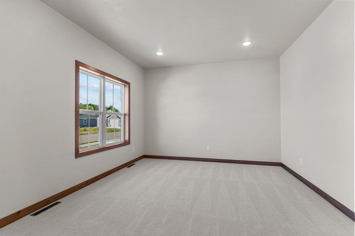 Bright empty room with large window in custom home by Midwest Design Homes, WI