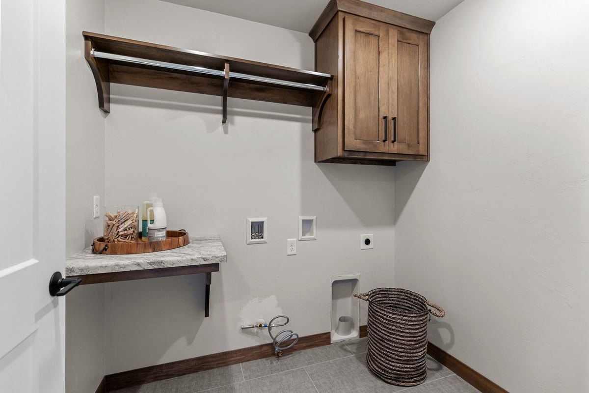 Laundry room with upper cabinets in custom home by Midwest Design Homes, Wisconsin
