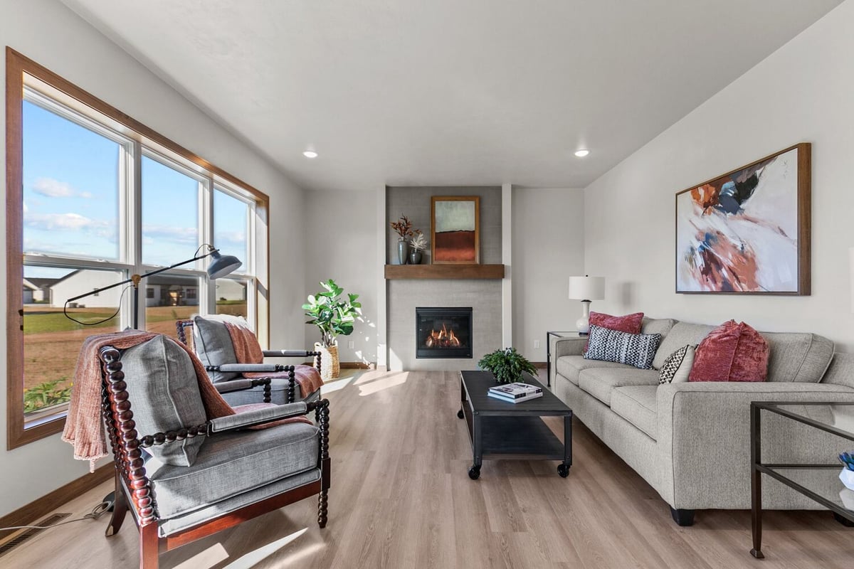 Living room with fireplace and large windows in Midwest Design Homes custom home, WI