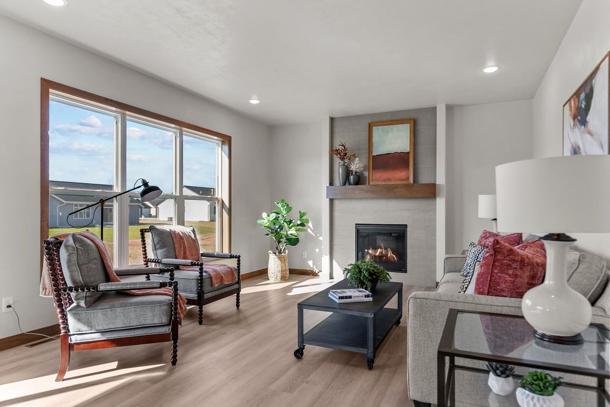 Living room with fireplace and seating in Kaukauna custom home by Midwest Design Homes