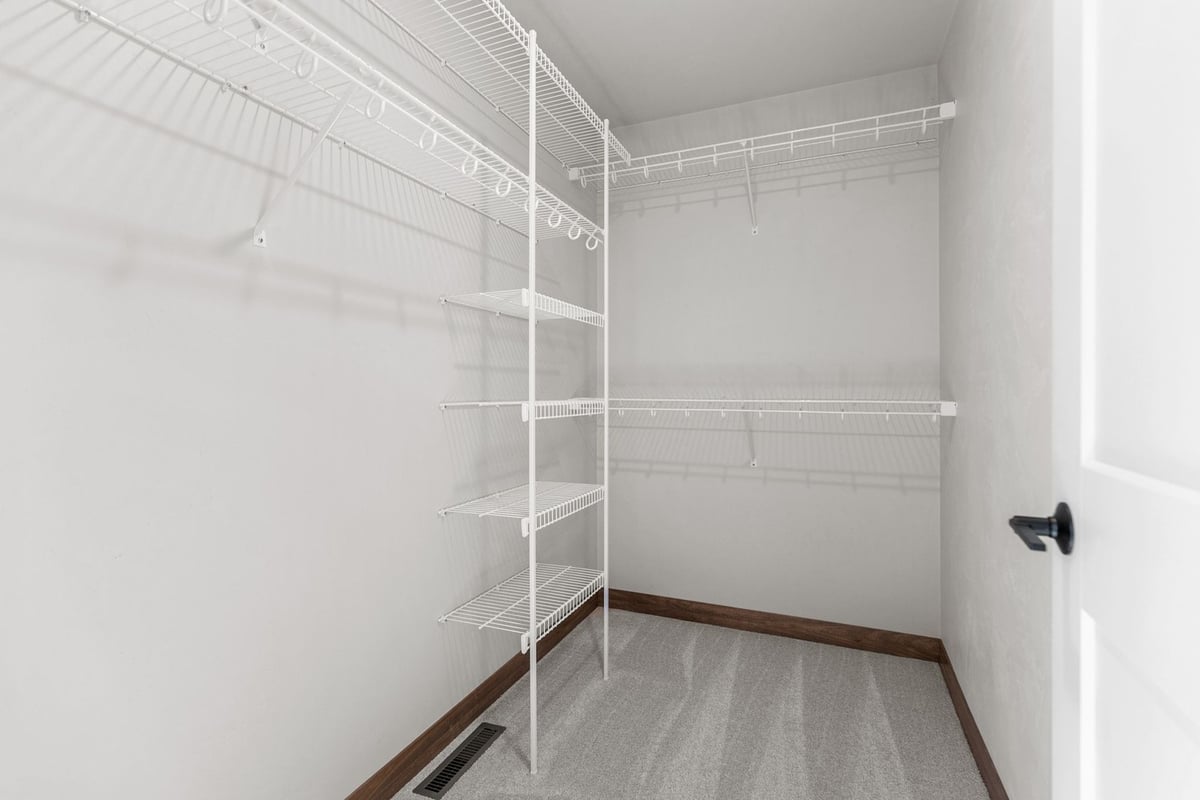 Walk-in closet with wire shelving in custom Midwest Design Homes build, Wisconsin