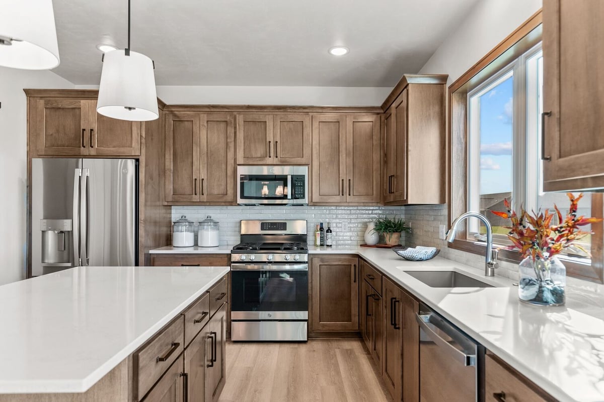 Wisconsin custom kitchen with quartz counters and wood cabinets by Midwest Design Homes