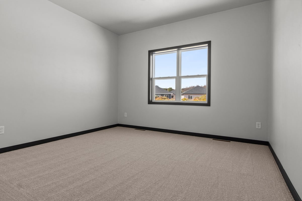 Bedroom with natural light and window view by Midwest Design Homes in Fremont, WI