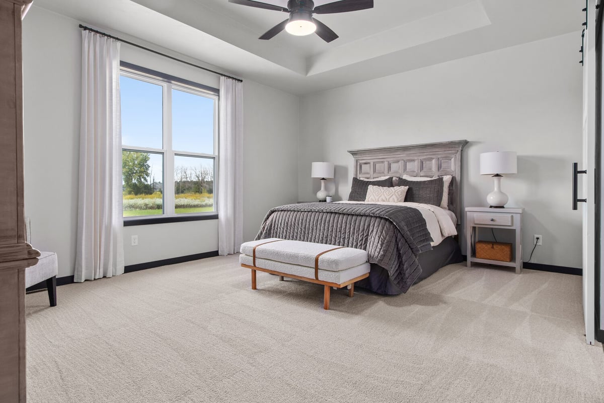 Custom-built bedroom with neutral tones by Midwest Design Homes in De Pere, WI
