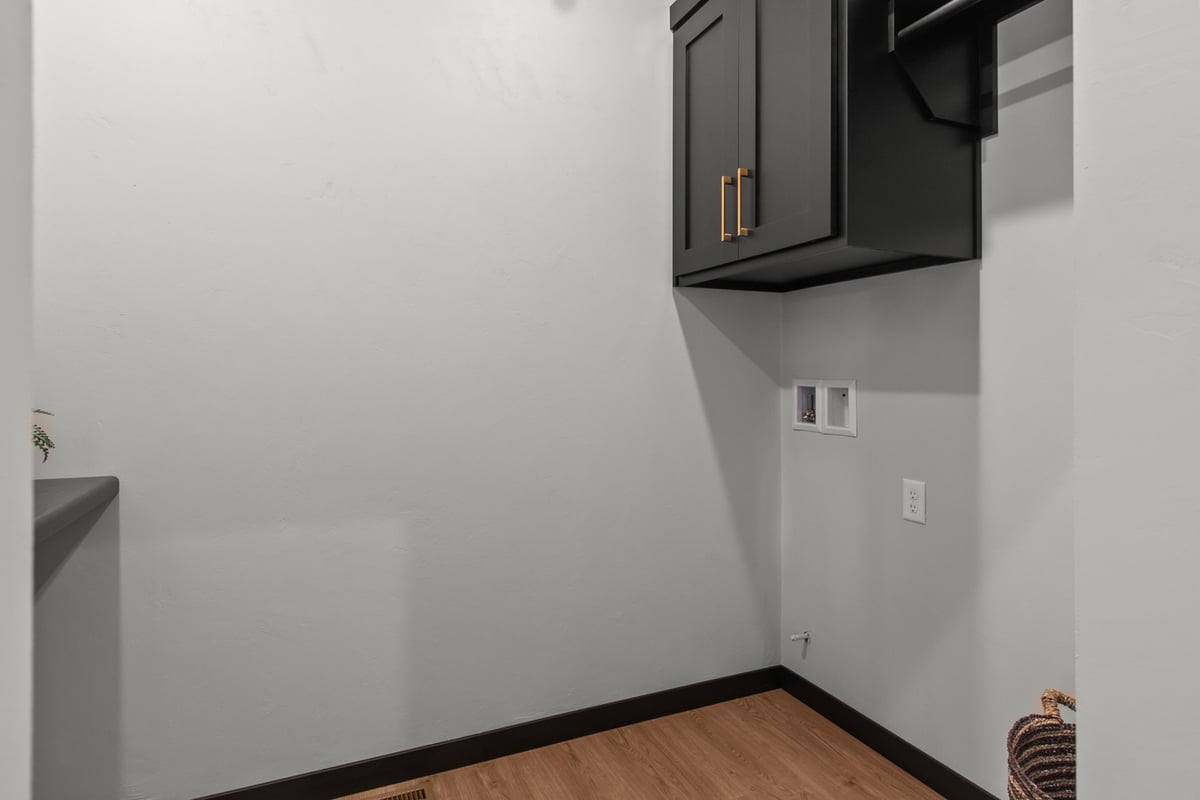 Laundry nook with cabinet and hookups by Midwest Design Homes in Appleton, WI