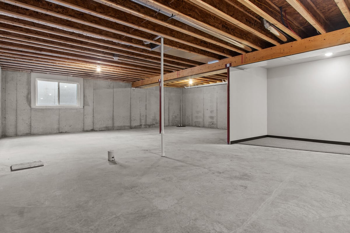 Unfinished basement with concrete floors by Midwest Design Homes in Green Bay, WI