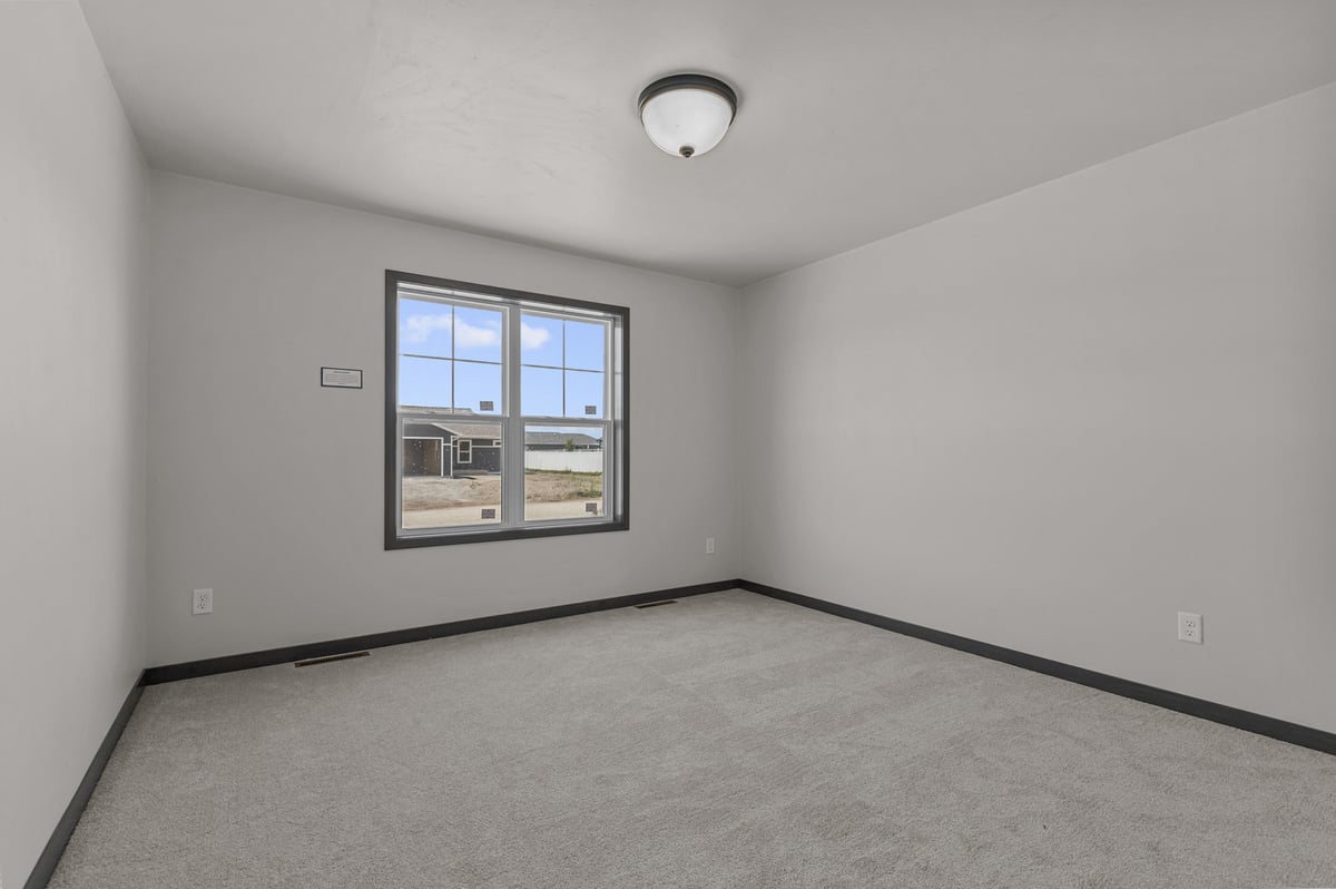 Custom home bedroom with large window by Midwest Design Homes in Kaukauna, Wisconsin