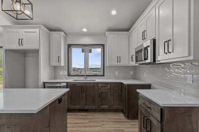 Custom kitchen with white uppers and dark lowers by Midwest Design Homes in WI