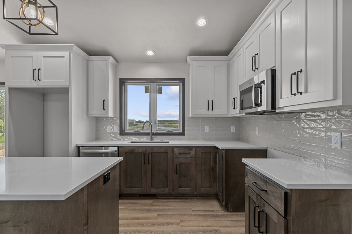 Custom kitchen with white uppers and dark lowers by Midwest Design Homes in WI