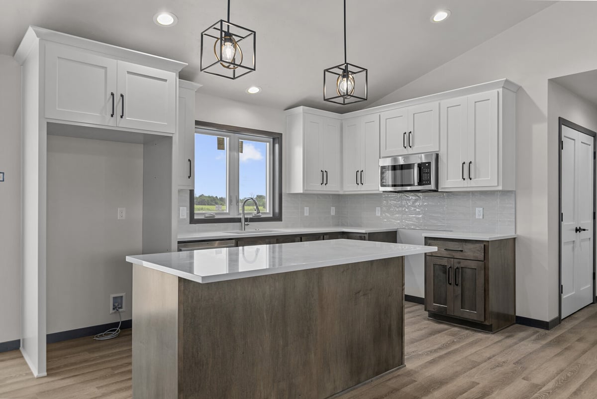 Island kitchen with pendant lights by Midwest Design Homes in Kaukauna, WI