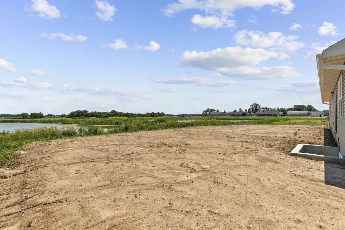 Lot and pond view from side of custom home by Midwest Design Homes in Wisconsin