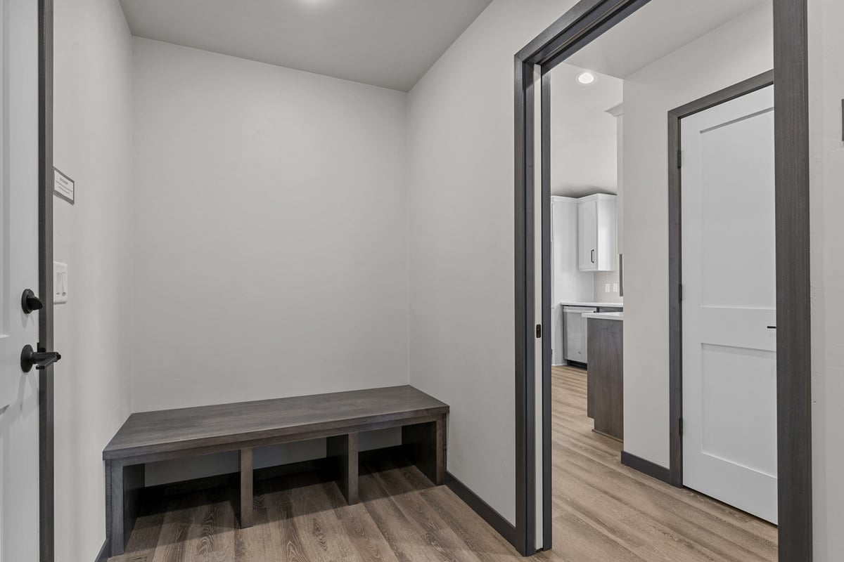 Mudroom entry with wood bench in custom Wisconsin home by Midwest Design Homes