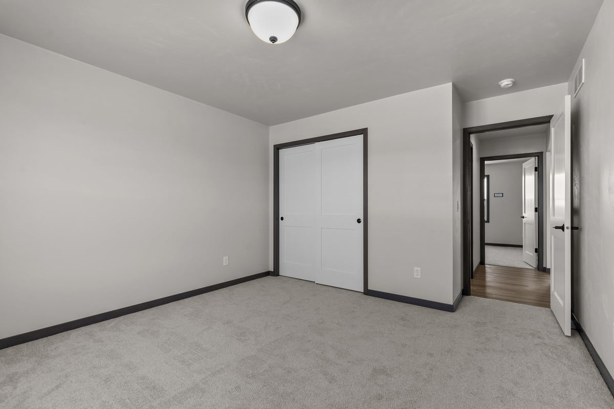 Neutral bedroom remodel in custom home by Midwest Design Homes in Kaukauna, Wisconsin