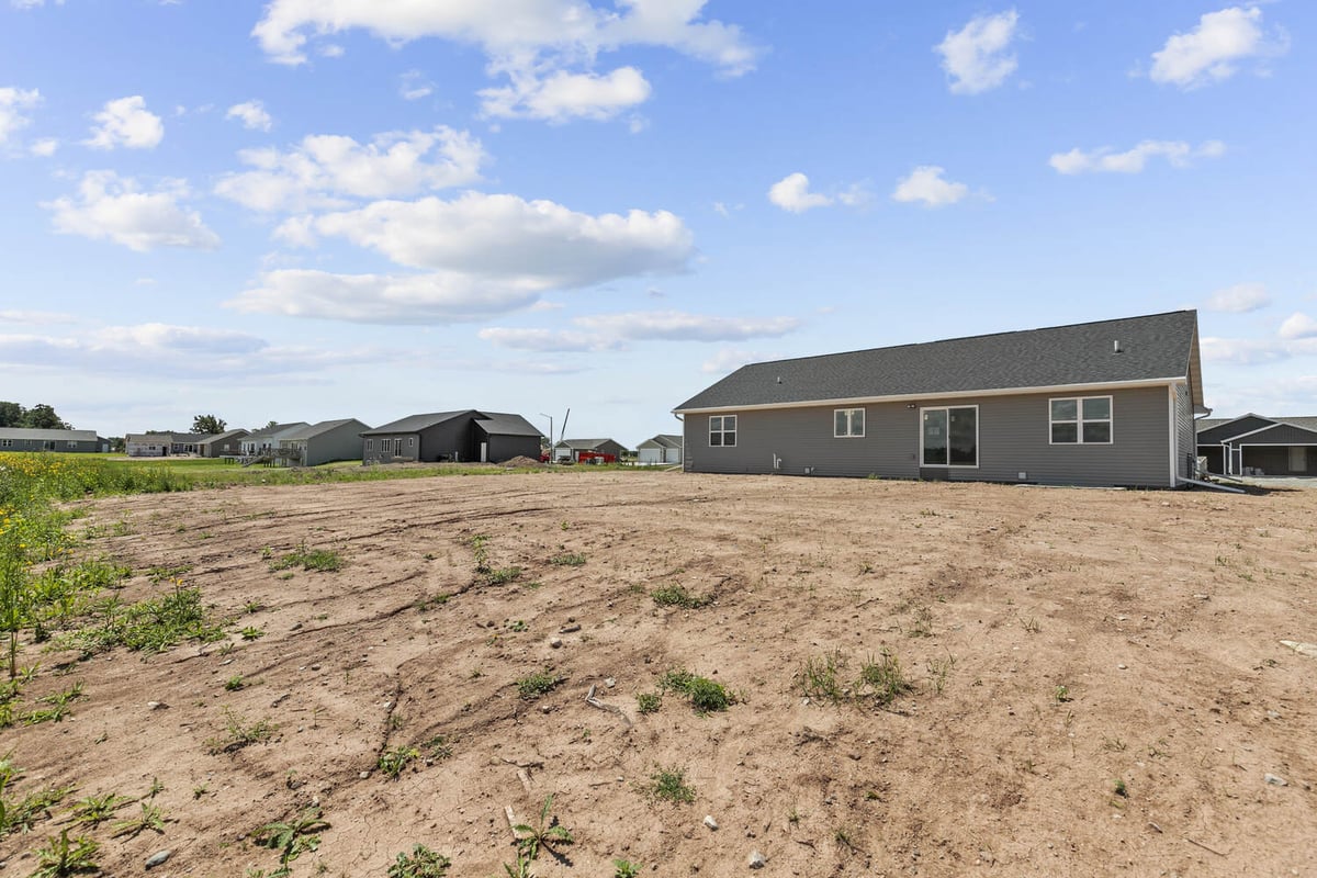 Rear view of custom home with sliding glass door by Midwest Design Homes in Wisconsin