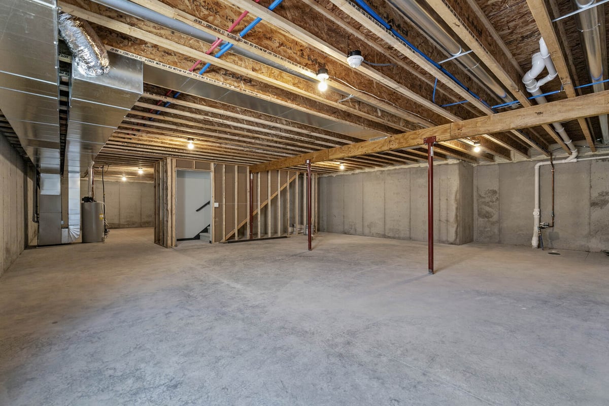 Unfinished basement space with HVAC in Wisconsin build by Midwest Design Homes