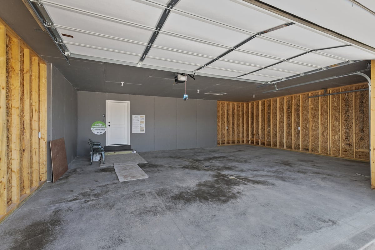 Unfinished garage space in Wisconsin home by Midwest Design Homes