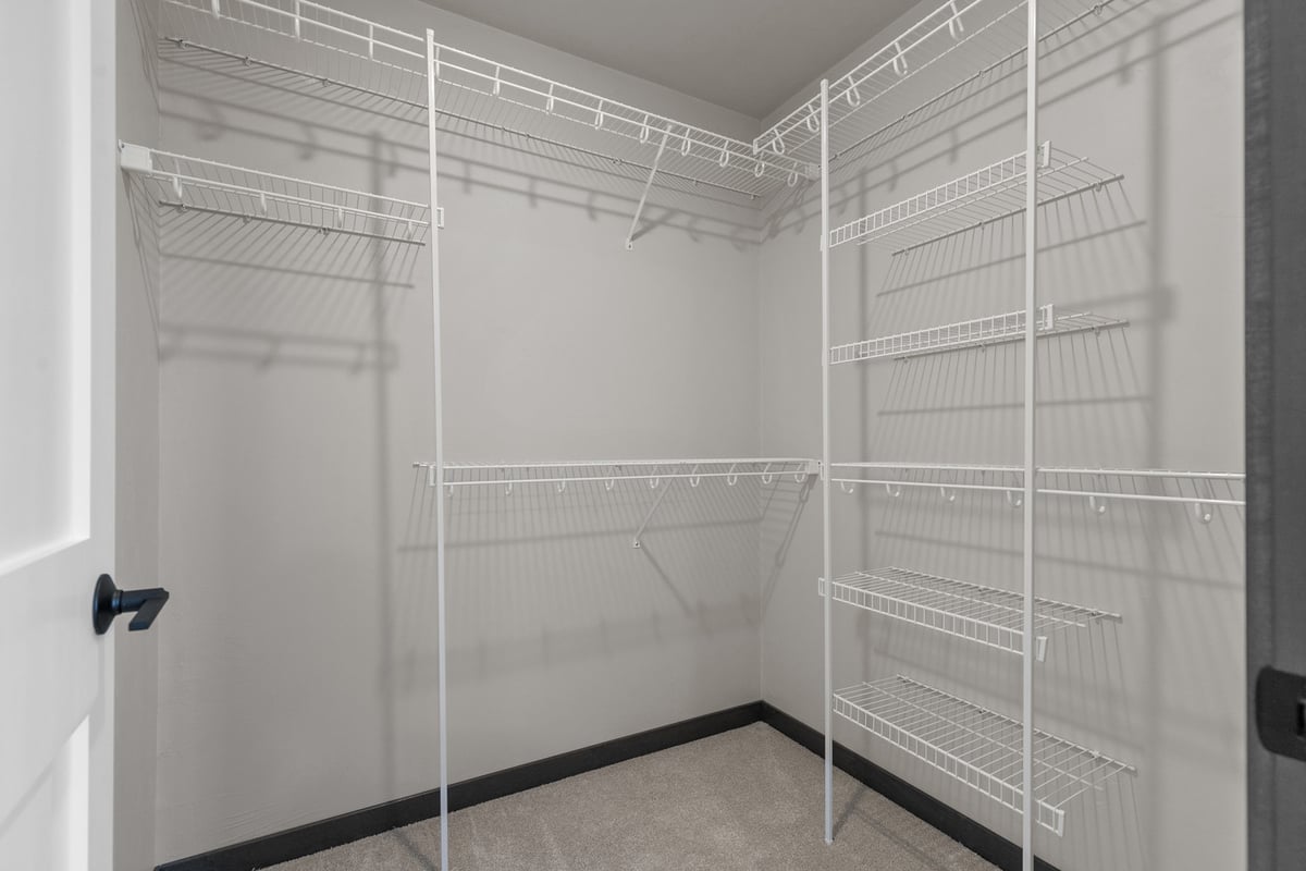 Walk-in closet with white wire shelving by Midwest Design Homes in Wisconsin