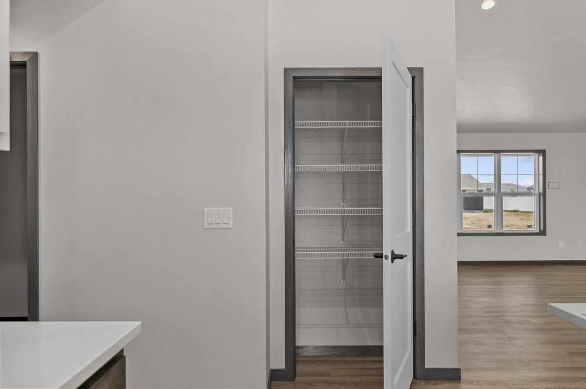 Walk-in pantry with wire shelving in custom home by Midwest Design Homes in WI
