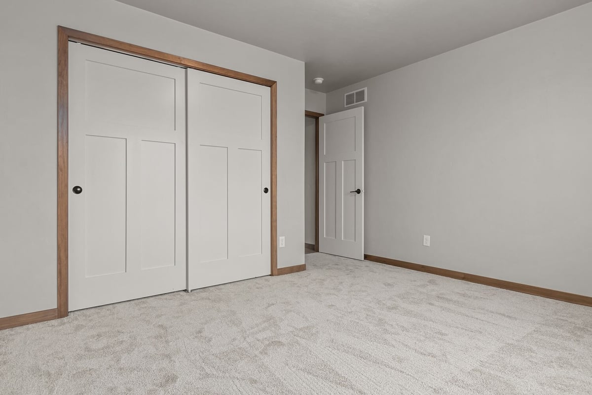 Bedroom remodel with sliding closet doors by Midwest Design Homes in Appleton, WI