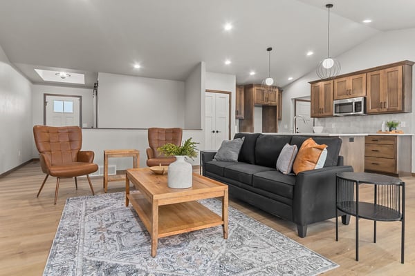 Open concept living room with leather chairs by Midwest Design Homes in Appleton, WI