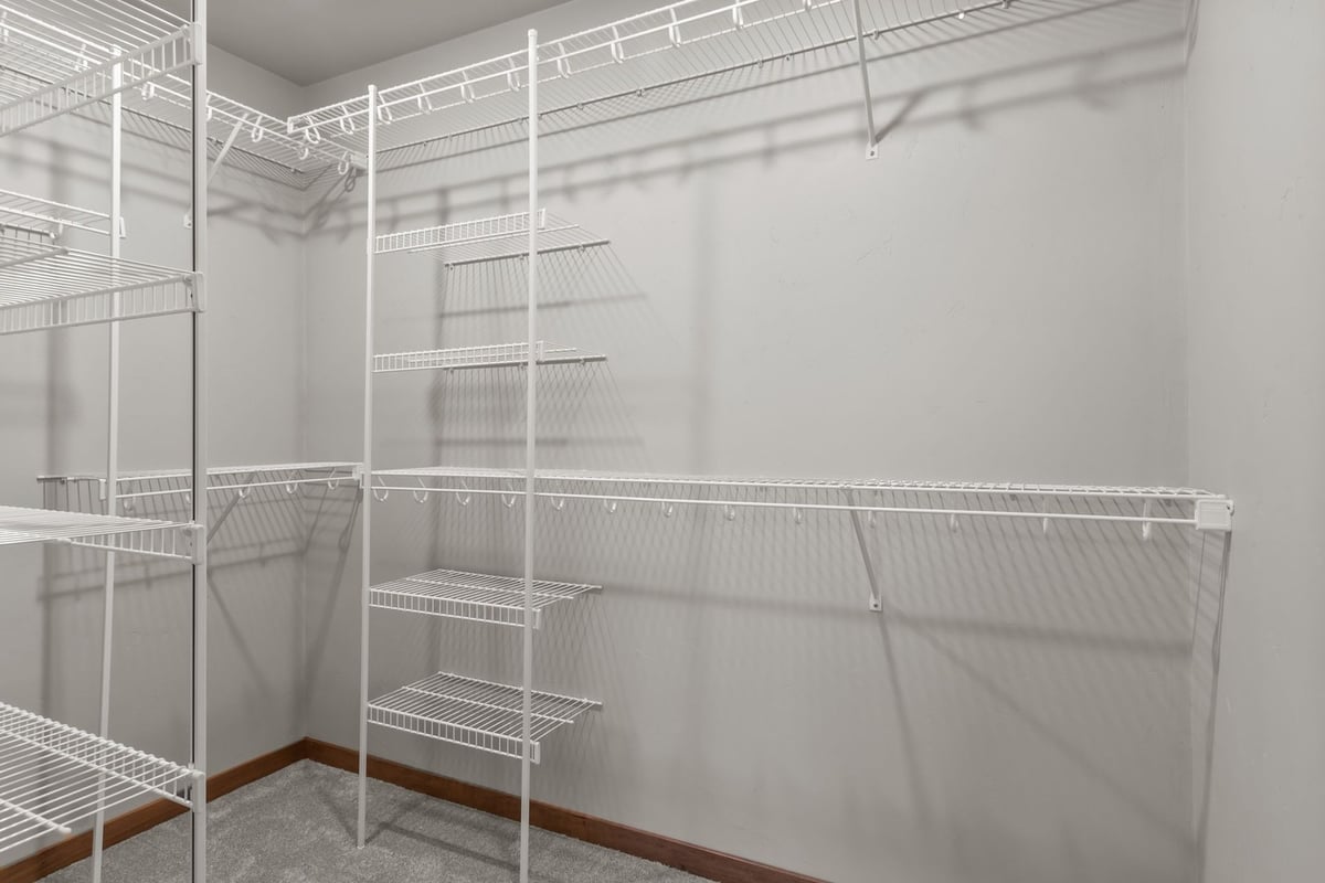 Spacious walk-in closet with white wire shelves by Midwest Design Homes in De Pere, WI