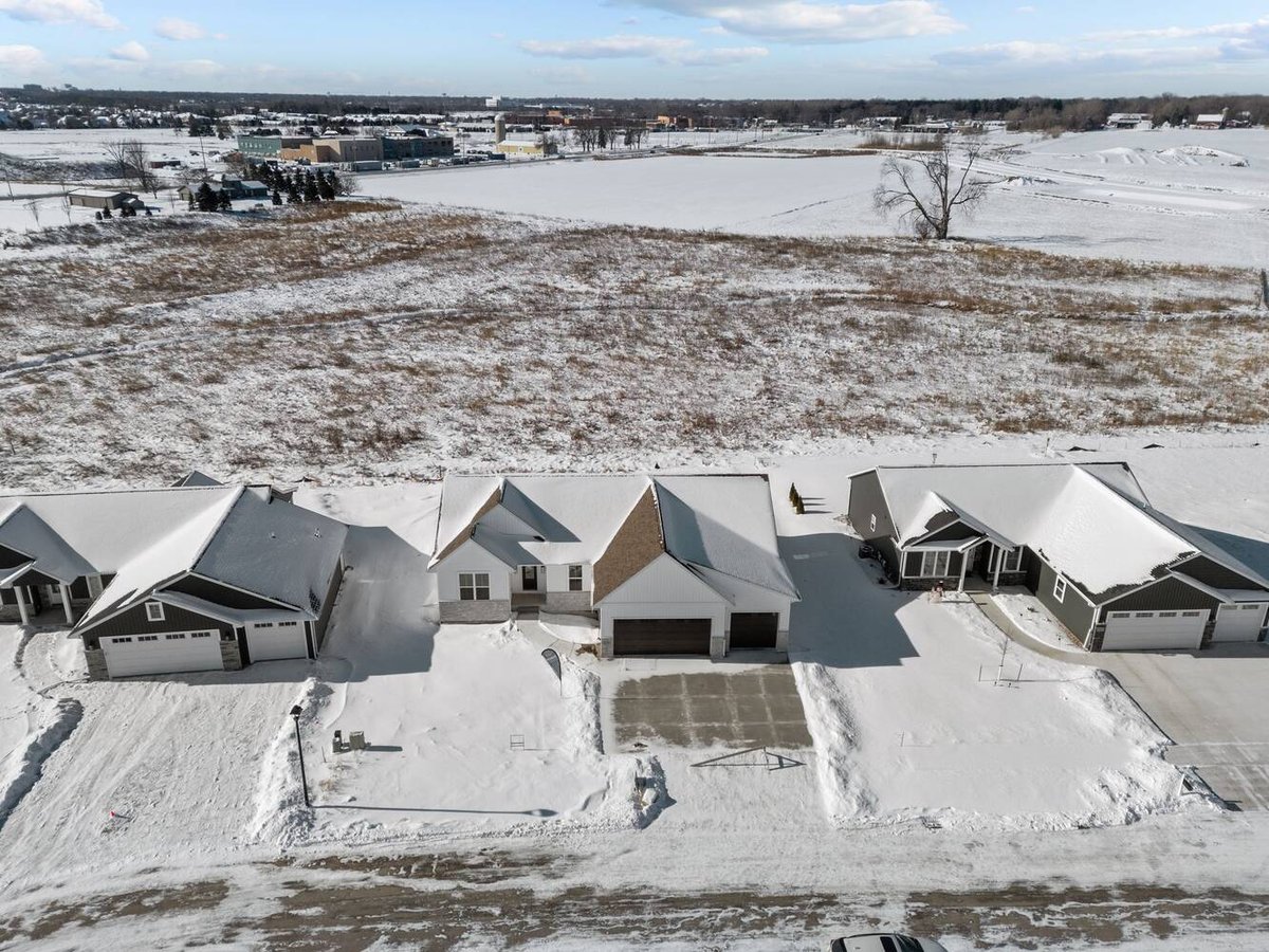 Aerial view of snowy custom home and neighborhood in Kaukauna, WI by Midwest Design Homes