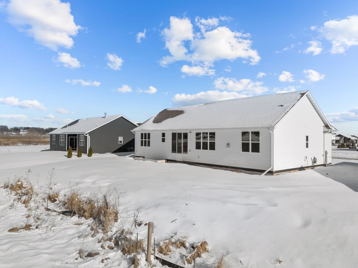 Backyard view of custom-built home with snow by Midwest Design Homes in Kaukauna, WI