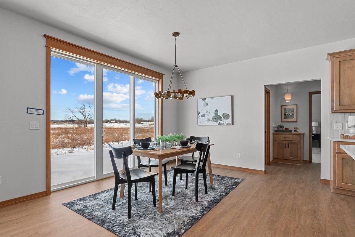Dining room with modern chandelier in custom home by Midwest Design Homes in Kaukauna, WI